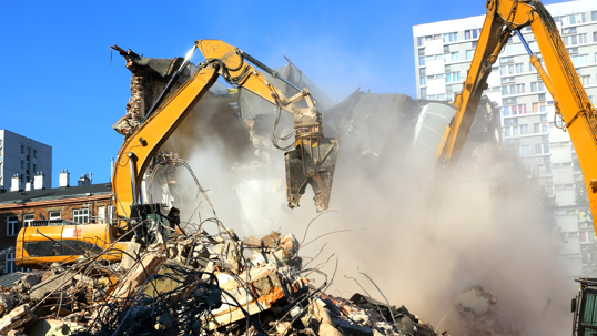 Two cranes at a demolition site