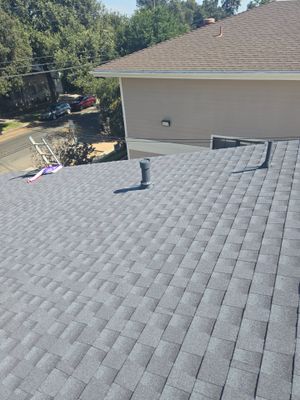 New shingles and pipe flashings on a Mayfield School slope during the 2024 reroof