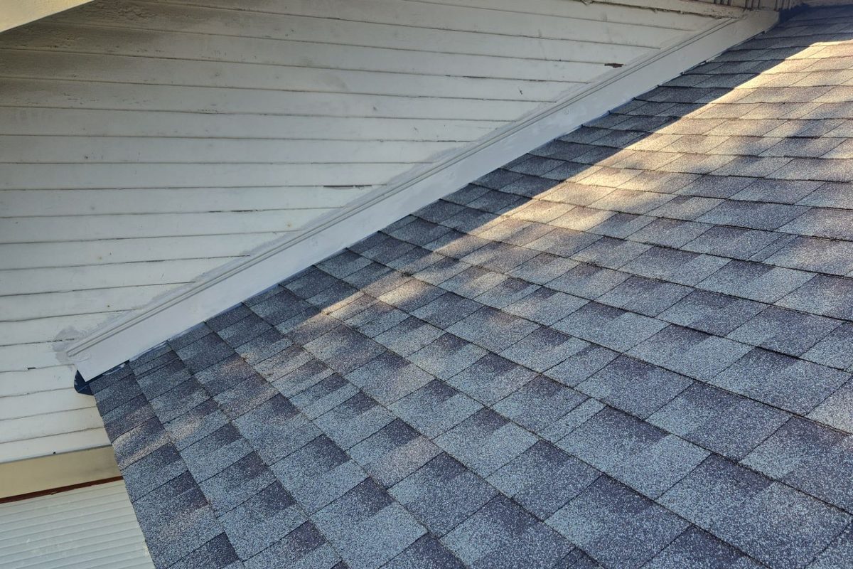 Sloped shingle roof meeting a gable wall on a Long Beach home