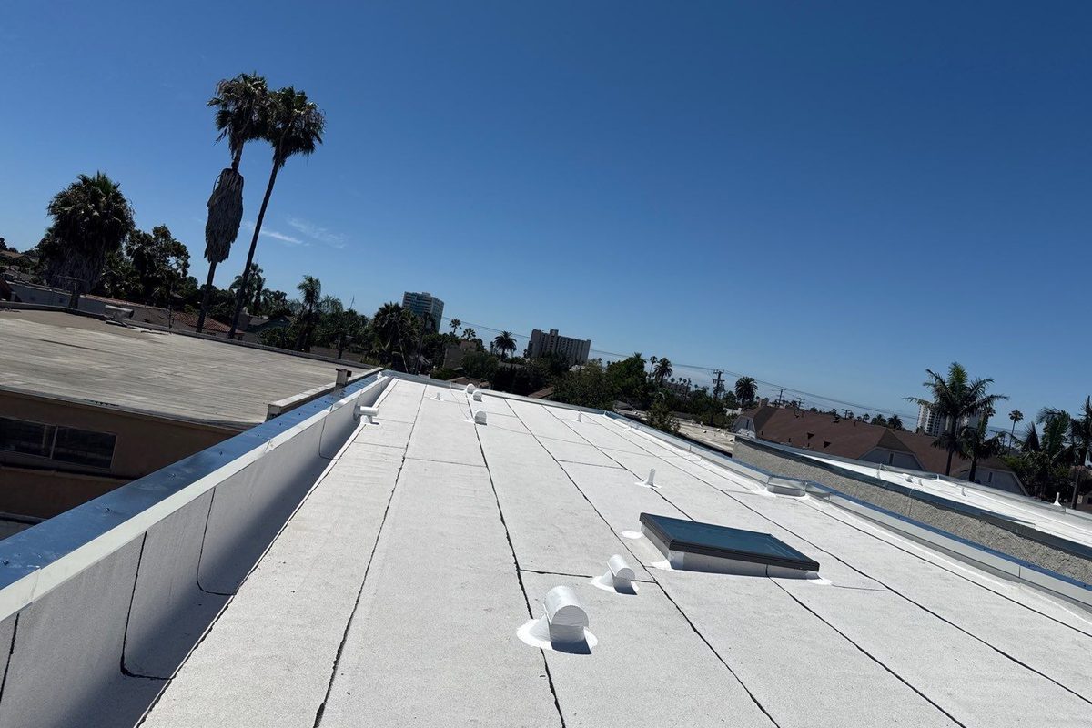 Metal coping cap along the top of a parapet wall on a finished Long Beach flat roof