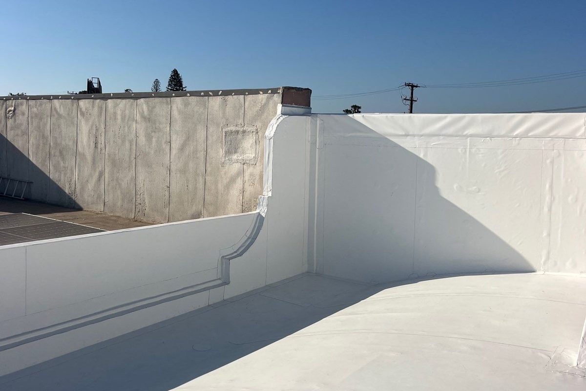 Parapet walls wrapped in white membrane on a finished Belmont Shore commercial roof