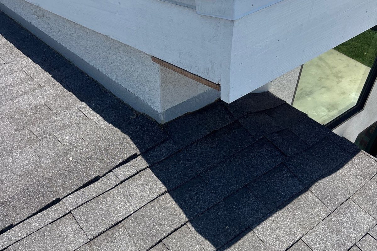 Metal edge trim along the edge of a finished shingle roof in Long Beach